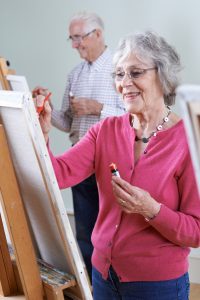 Lady and gent painting at easels