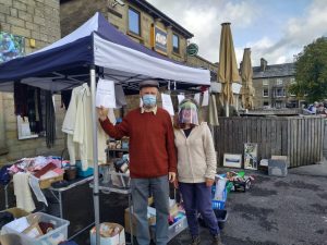 Man and woman standing by pop up marquee outside Connex offices