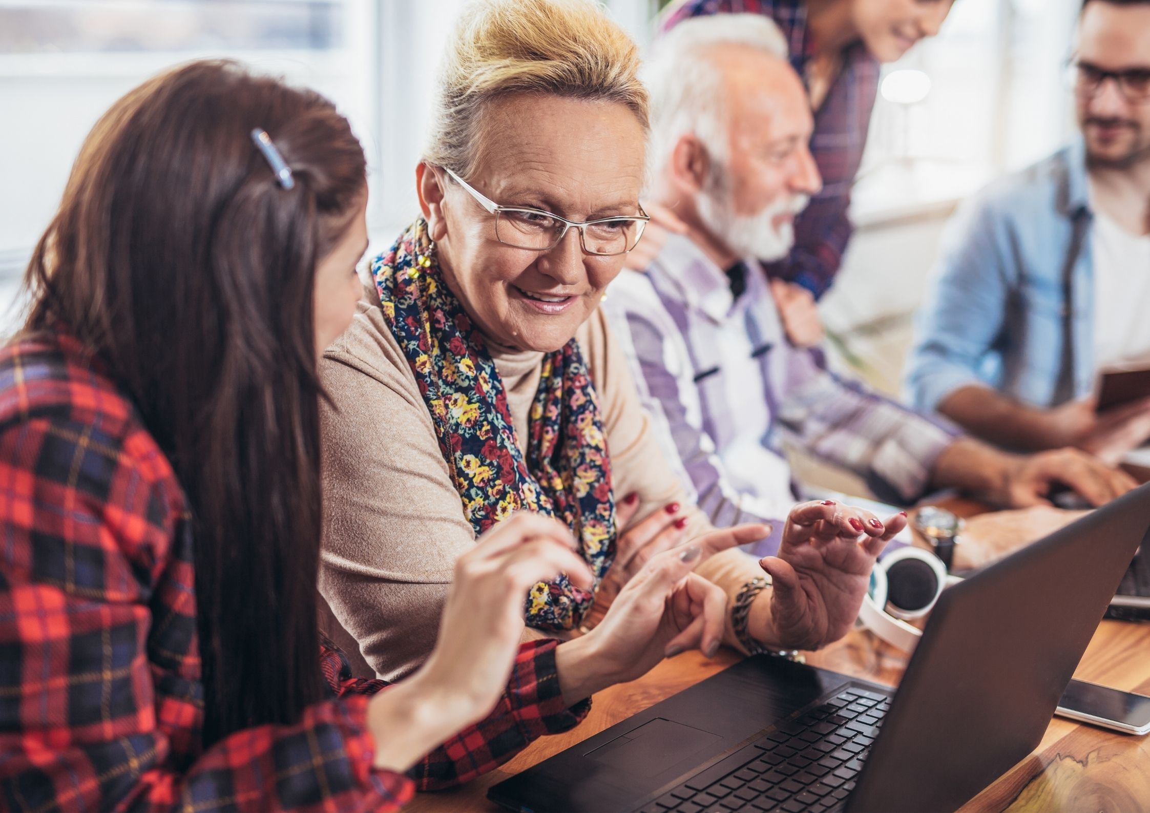 Tea, talk and tech helping use a laptop