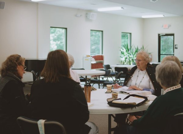 Older women engage in a thoughtful Bible study session at a local church in Brevard, NC.